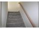 Carpeted staircase with light wood handrail and white walls leading to the second floor at 70 Basil Ct, Franklinton, NC 27525