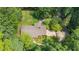 A high aerial showcasing mature trees and a well-maintained lawn at 712 Orange High School Rd, Hillsborough, NC 27278