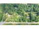 Aerial view of a tree-surrounded property with house, marked by yellow border at 712 Orange High School Rd, Hillsborough, NC 27278