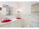 Bathroom featuring red sinks, patterned wallpaper, vanity, and a large mirror at 712 Orange High School Rd, Hillsborough, NC 27278