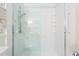 Walk-in shower with glass door, white tile surround, and grab bars at 712 Orange High School Rd, Hillsborough, NC 27278