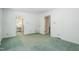 Bedroom with green carpet, white walls, and access to the ensuite bathroom at 712 Orange High School Rd, Hillsborough, NC 27278