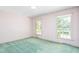 Empty bedroom with two windows and carpet at 712 Orange High School Rd, Hillsborough, NC 27278