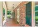 Inviting brick home exterior featuring a covered entrance, black shutters, and well-maintained landscaping at 712 Orange High School Rd, Hillsborough, NC 27278
