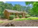 Charming brick home featuring a well-manicured lawn, lush landscaping, and a welcoming front entrance at 712 Orange High School Rd, Hillsborough, NC 27278