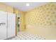 Eat-in kitchen featuring a refrigerator and bright, floral wallpaper at 712 Orange High School Rd, Hillsborough, NC 27278