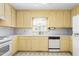 Traditional kitchen with yellow cabinetry, white countertops, a window, and appliances at 712 Orange High School Rd, Hillsborough, NC 27278