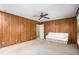 Living room with wood-paneled walls and neutral carpet at 712 Orange High School Rd, Hillsborough, NC 27278