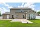 Back of house featuring a large concrete patio with green grass at 760 Stackhurst Way, Wake Forest, NC 27587