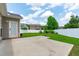Backyard featuring a concrete patio and ample green space with a white fence at 760 Stackhurst Way, Wake Forest, NC 27587