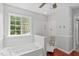 Bathroom showcasing a soaking tub with jets and natural light from a window at 760 Stackhurst Way, Wake Forest, NC 27587