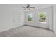 Bedroom with carpet, ceiling fan, and two windows providing natural light at 760 Stackhurst Way, Wake Forest, NC 27587