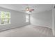 Neutral bedroom featuring plush carpet, two windows, and ceiling fan at 760 Stackhurst Way, Wake Forest, NC 27587