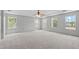 Spacious bedroom with plush carpet, a ceiling fan, and large windows at 760 Stackhurst Way, Wake Forest, NC 27587