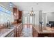 Well-appointed kitchen with granite countertops and island seating, flowing into the living area at 760 Stackhurst Way, Wake Forest, NC 27587