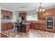 Well-equipped kitchen boasts stainless steel appliances, island, and stylish tile flooring at 760 Stackhurst Way, Wake Forest, NC 27587