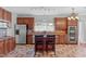 Spacious kitchen with stainless steel appliances, a center island, and custom tile backsplash at 760 Stackhurst Way, Wake Forest, NC 27587