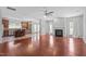 Open-concept living room featuring hardwood floors, fireplace, and seamless access to the kitchen at 760 Stackhurst Way, Wake Forest, NC 27587