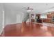 Open-concept living area flows into the kitchen, featuring hardwood floors and neutral tones at 760 Stackhurst Way, Wake Forest, NC 27587