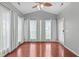 Bright sunroom with hardwood floors, ceiling fan, and abundant natural light through large windows at 760 Stackhurst Way, Wake Forest, NC 27587