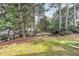 Home backyard with mature trees providing shade and privacy at 7708 Falcon Rest Cir, Raleigh, NC 27615