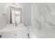 Bathroom with a bathtub and shower surround, a white vanity, and updated fixtures at 7708 Falcon Rest Cir, Raleigh, NC 27615