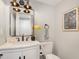 Elegant bathroom with a modern vanity, stylish mirror, and updated fixtures at 7708 Falcon Rest Cir, Raleigh, NC 27615