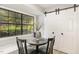 Bright breakfast nook with a large window and stylish sliding door access to laundry appliances at 7708 Falcon Rest Cir, Raleigh, NC 27615