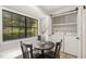 Bright breakfast nook with a large window and sliding barn door revealing a laundry area at 7708 Falcon Rest Cir, Raleigh, NC 27615