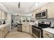 Well-equipped kitchen with stainless steel appliances and seamless flow to dining and living areas at 7708 Falcon Rest Cir, Raleigh, NC 27615