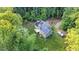 Aerial view of home featuring solar panels, backyard and wooded surroundings at 8226 Mcarthur Park Dr, Efland, NC 27243