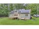 Back of home featuring solar panels, a deck, and a lush, expansive yard at 8226 Mcarthur Park Dr, Efland, NC 27243