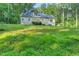 Expansive back yard providing a serene setting for this home with a solar panels at 8226 Mcarthur Park Dr, Efland, NC 27243