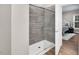 Modern shower with glass door and gray tiling, connected to the main bedroom at 8226 Mcarthur Park Dr, Efland, NC 27243