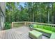 Inviting deck featuring a comfortable outdoor seating area surrounded by a lush forest backdrop at 8226 Mcarthur Park Dr, Efland, NC 27243