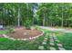 Tranquil front yard with stone pathway and a landscaped island for outdoor enjoyment at 8226 Mcarthur Park Dr, Efland, NC 27243