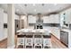 Well-appointed kitchen featuring an island with seating, stainless steel appliances, and modern finishes at 8226 Mcarthur Park Dr, Efland, NC 27243