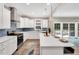 Bright and modern kitchen featuring an island, white cabinets, and stainless steel appliances at 8226 Mcarthur Park Dr, Efland, NC 27243