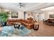 Open living room with coffered ceilings, leather sofa, and staircase at 8226 Mcarthur Park Dr, Efland, NC 27243
