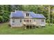 Rear exterior featuring a deck and solar panels atop the charming home at 8226 Mcarthur Park Dr, Efland, NC 27243
