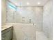 Modern bathroom with a spacious shower featuring sleek fixtures and white marble-look tiles at 89 Merle Dr, Wendell, NC 27591