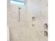 Close-up of a spacious shower featuring white marble-patterned walls, built-in niche, and chrome fixtures at 89 Merle Dr, Wendell, NC 27591