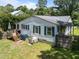 Rear view of a lovely home boasting a wooden deck and a generous backyard at 101 Goldston Dr, Carrboro, NC 27510