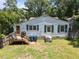 Rear view of a charming home featuring a wooden deck and a spacious backyard at 101 Goldston Dr, Carrboro, NC 27510