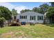 View of the back of the property with a small deck overlooking the lawn and garden area at 101 Goldston Dr, Carrboro, NC 27510