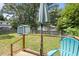 Backyard view from the deck, featuring an umbrella, a storage shed, and mature trees at 101 Goldston Dr, Carrboro, NC 27510