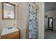Bathroom with shower, sink, and cabinet with a colorful shower curtain at 101 Goldston Dr, Carrboro, NC 27510