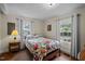 Comfortable bedroom with natural light, floral bedding, and classic design elements at 101 Goldston Dr, Carrboro, NC 27510