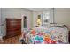 Inviting bedroom featuring hardwood floors, a floral bedspread, and natural light at 101 Goldston Dr, Carrboro, NC 27510