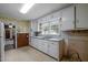 Practical kitchen featuring white cabinets, stainless steel sink, and ample natural light at 101 Goldston Dr, Carrboro, NC 27510